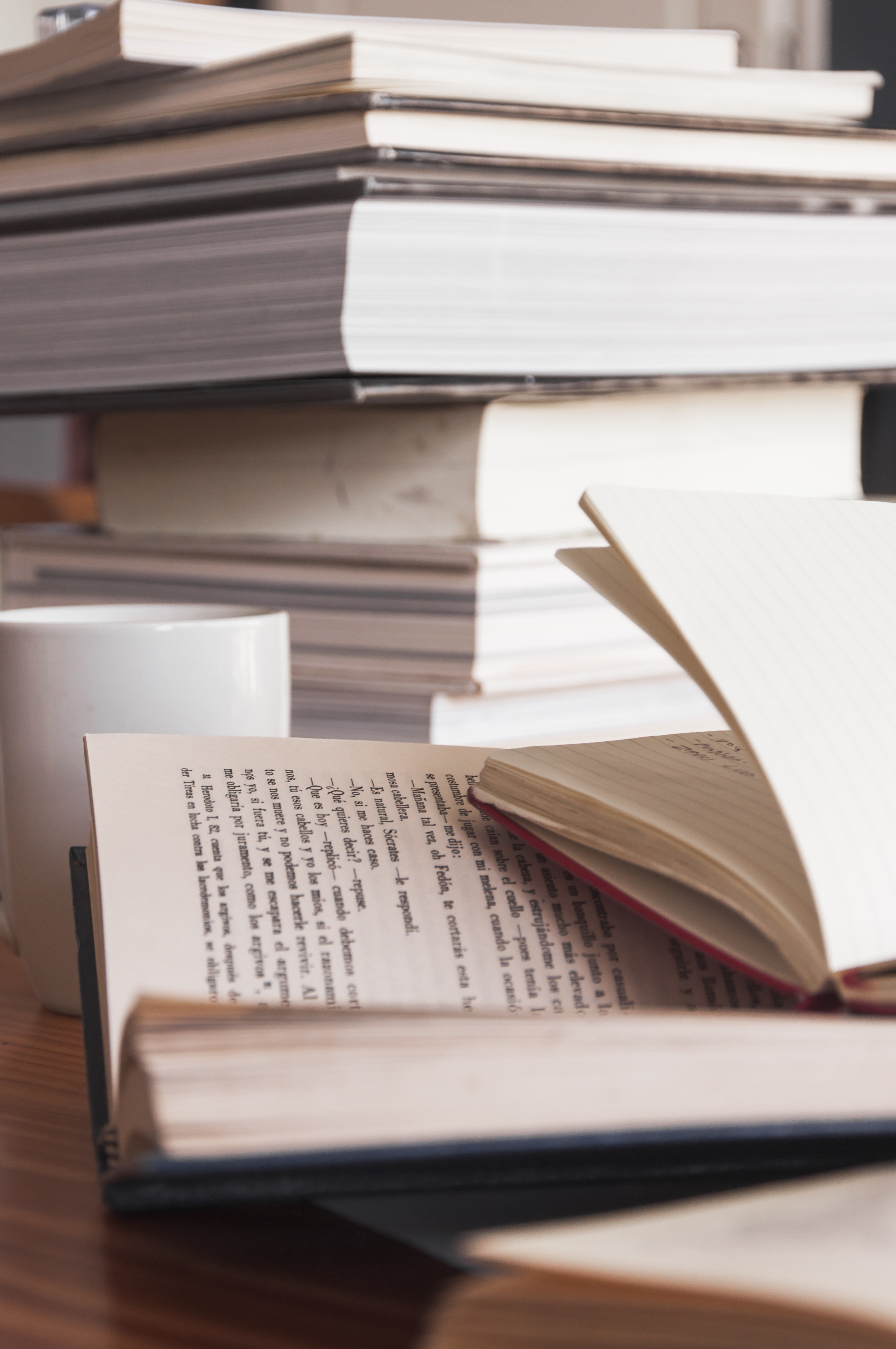 Books beside a mug